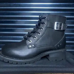 A pair of black boots sitting on top of a metal surface.