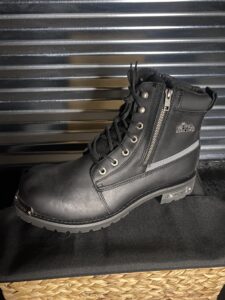 A pair of black boots sitting on top of a table.