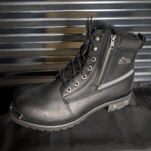A pair of black boots sitting on top of a table.