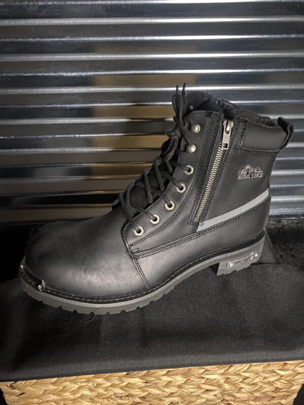A pair of black boots sitting on top of a table.