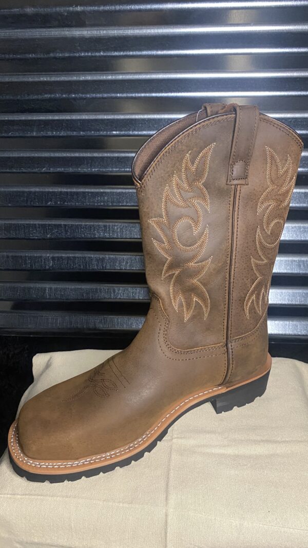 A brown cowboy boot sitting on top of a box.