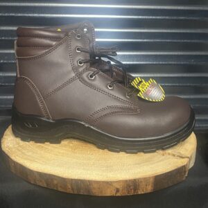A pair of brown work boots on top of a wooden board.