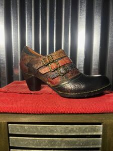 A pair of shoes sitting on top of a red table.