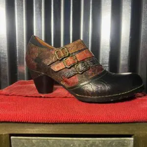 A pair of shoes sitting on top of a red table.