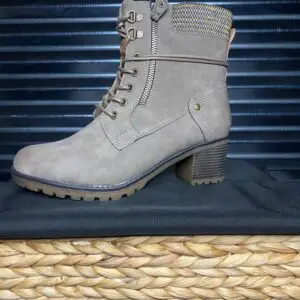 A pair of boots sitting on top of a basket.
