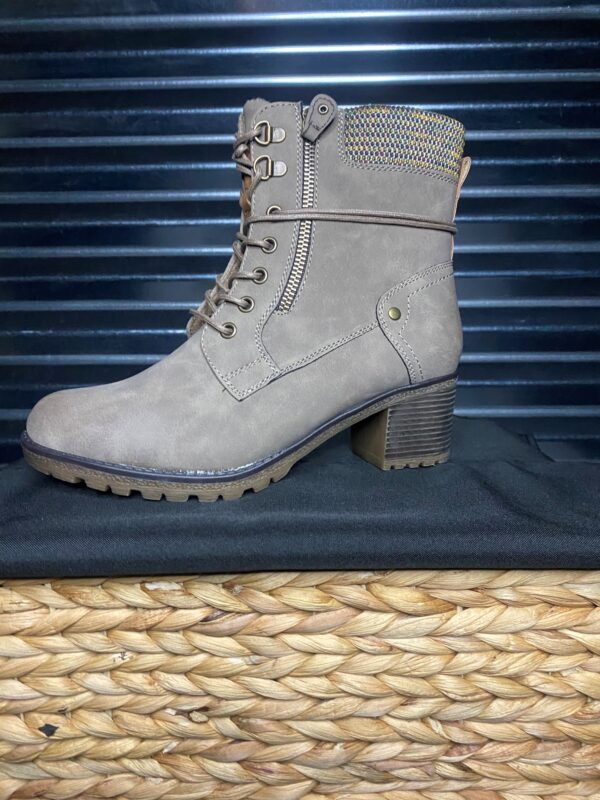 A pair of boots sitting on top of a basket.