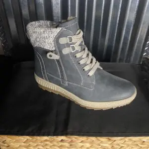 A pair of boots sitting on top of a black table.
