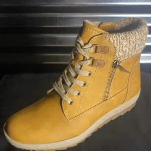 A pair of boots that are on the ground.