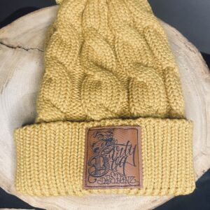 A yellow hat with a leather patch on top of it.