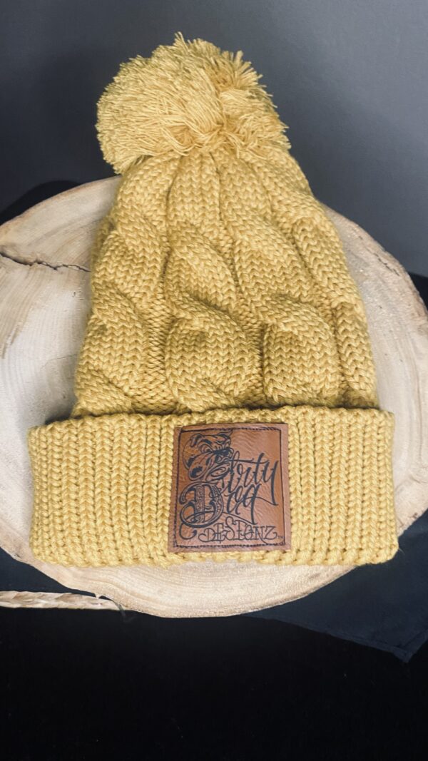 A yellow hat with a leather patch on top of it.