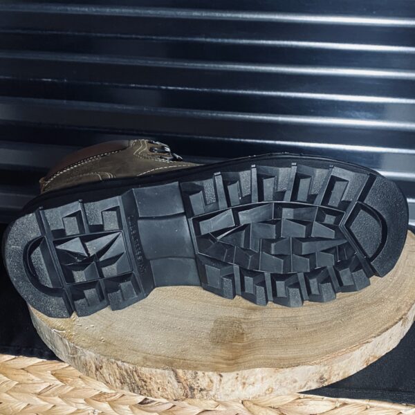 A pair of shoes sitting on top of a wooden block.
