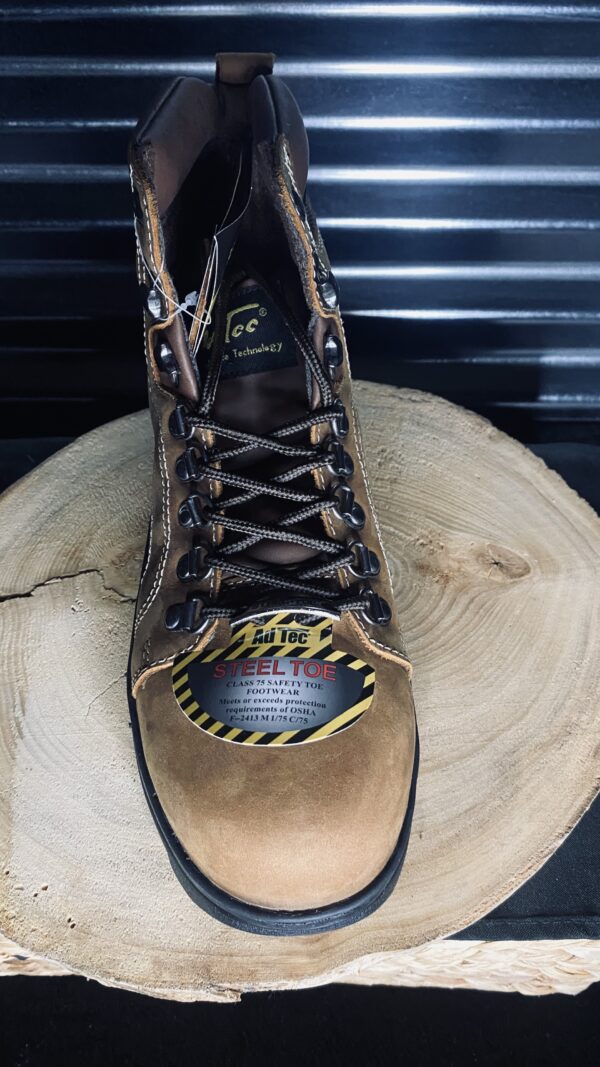 A pair of boots sitting on top of a tree stump.
