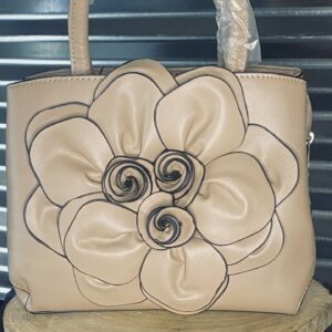 A purse that is made of leather with a flower on it.