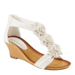 A white sandal with flowers on the side of it.