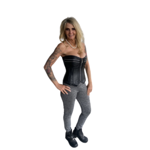 A woman in black corset and grey pants.