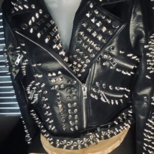 A black leather jacket with silver and white studs on it.
