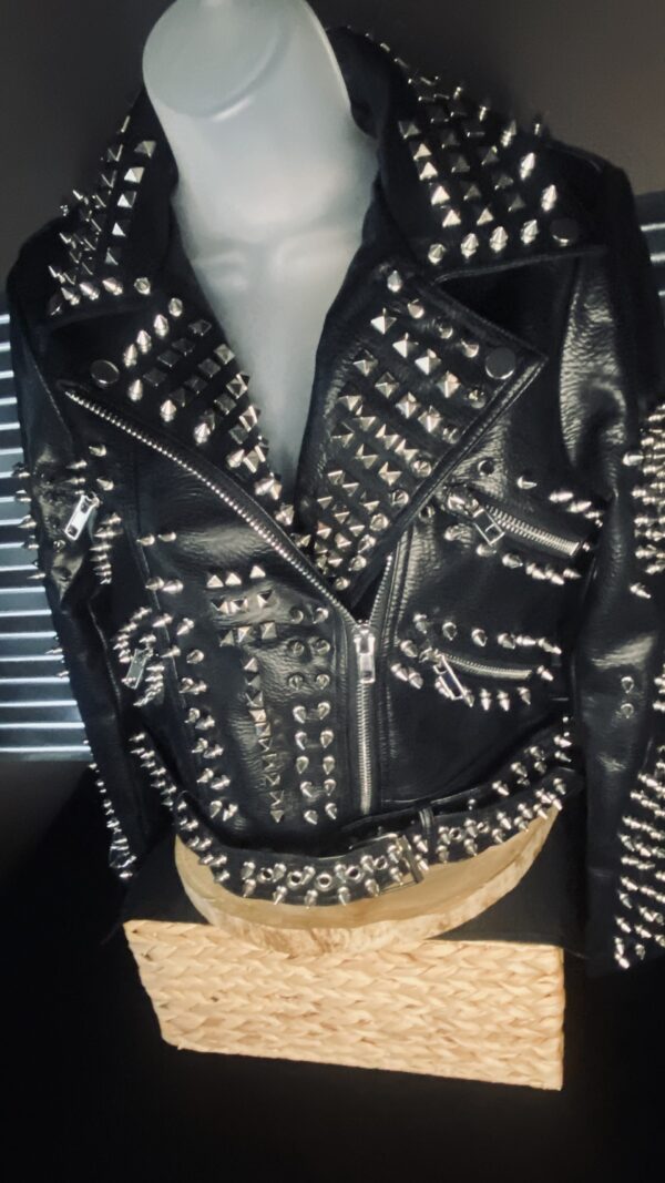 A black leather jacket with silver and white studs on it.