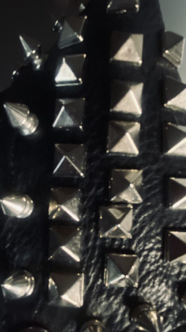 A close up of some metal studs on leather