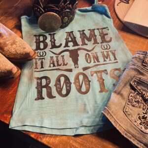 A t-shirt that says blame it all on my roots.