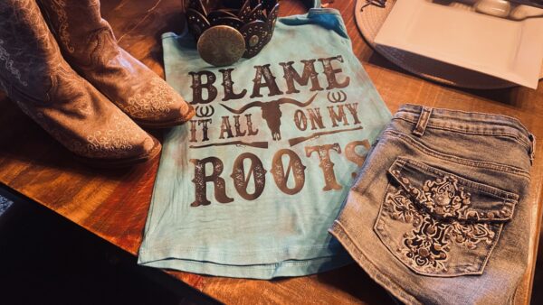 A t-shirt that says blame it all on my roots.