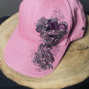 A pink hat with black and white designs on it.