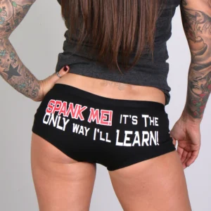 A woman with tattoos is wearing black underwear.
