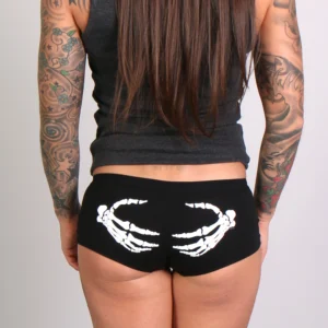 A woman with long hair and tattoos wearing black underwear.