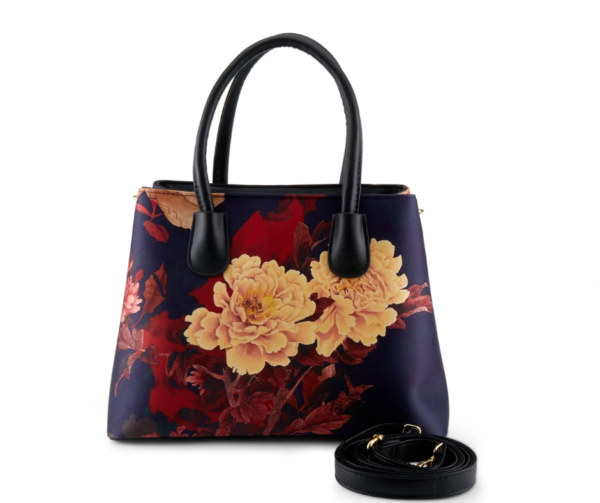 A bag with flowers on it and black strap.