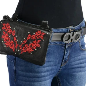 A woman wearing jeans and belt holding onto a purse