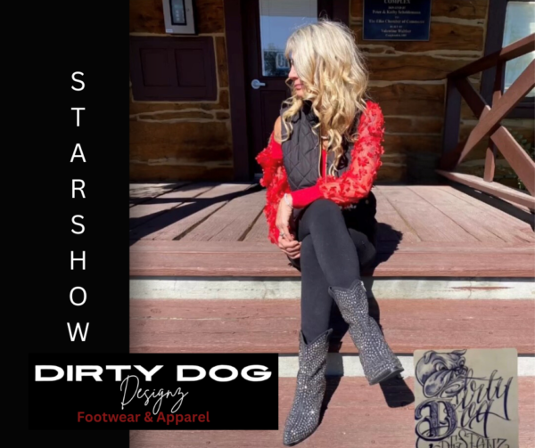 A woman sitting on steps wearing boots and a red shirt.