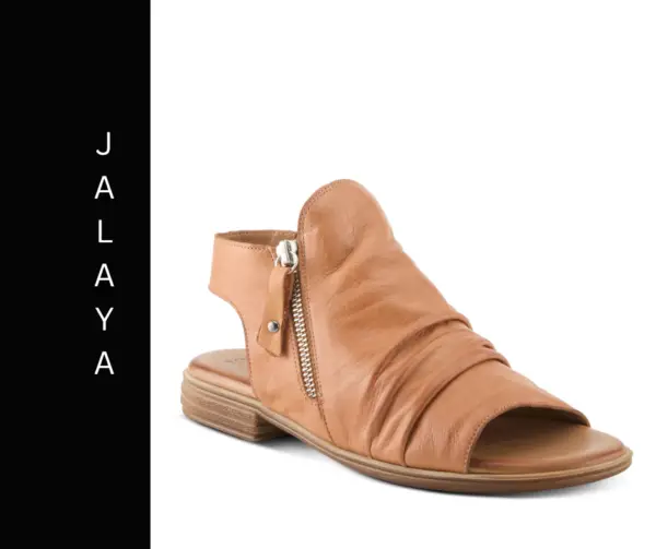 A tan sandal with a side zipper and a black label.