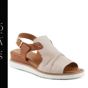 A pair of sandals that are tan and white.