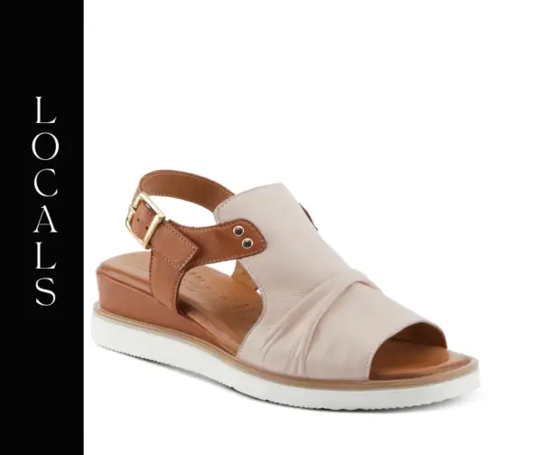A pair of sandals that are tan and white.