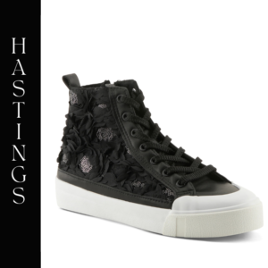 A black sneaker with flowers on the side of it.