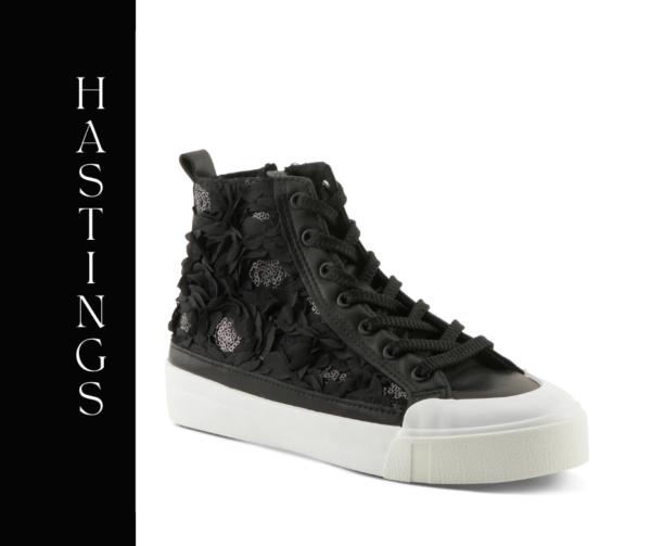 A black sneaker with flowers on the side of it.