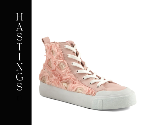 A pink sneaker with flowers on the side.